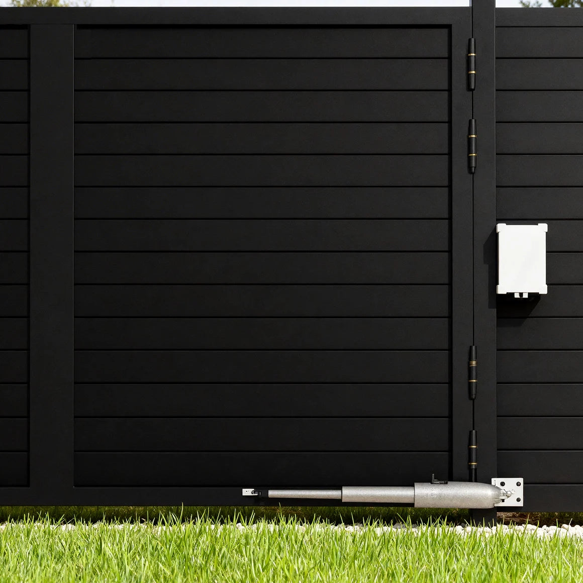 Close up of heavy duty linear arm opener motor installed on an automatic aluminum gate.