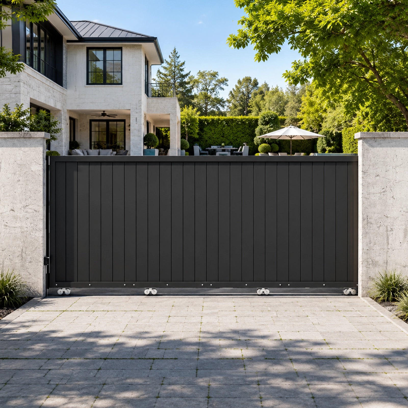 Closed 13.3x5.6ft black aluminum sliding driveway gate between modern concrete boundary walls.